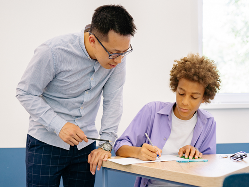 teacher helping student